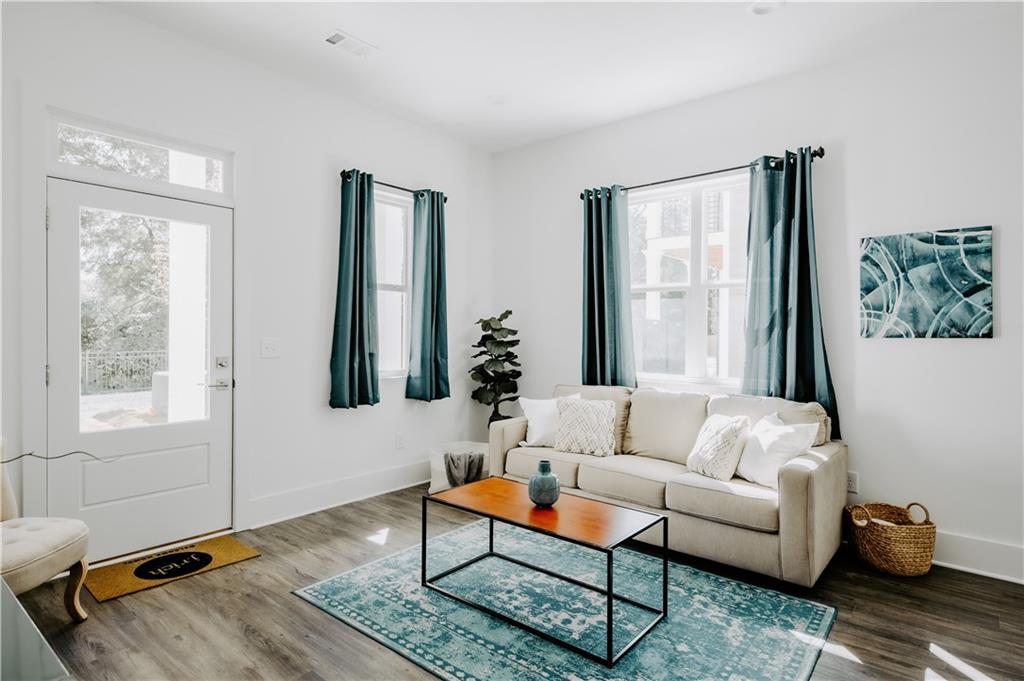 123 Mayson Avenue Northeast, Unit C Atlanta, GA 30307 - Photo 5 of 21 a living room with furniture and a window