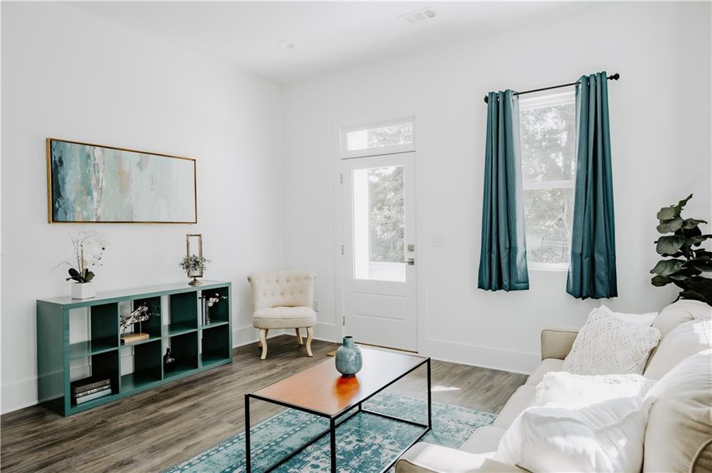 123 Mayson Avenue Northeast, Unit C Atlanta, GA 30307 - Photo 6 of 21 a living room with furniture a rug and a window