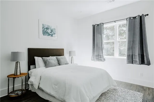 a bedroom with a large bed and a large window