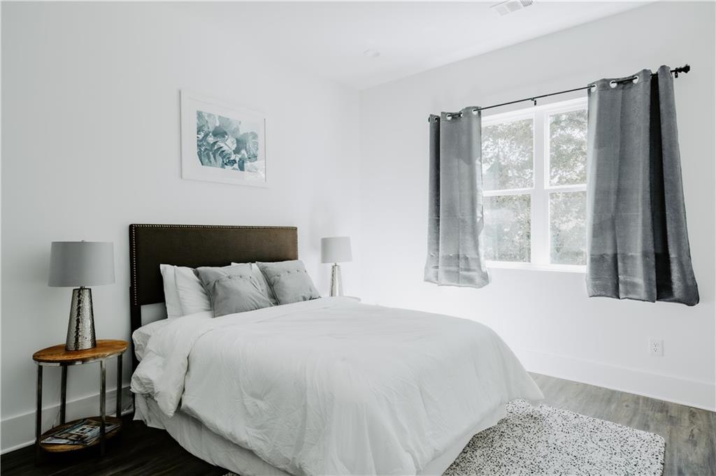 123 Mayson Avenue Northeast, Unit C Atlanta, GA 30307 - Photo 7 of 21 a bedroom with a large bed and a large window