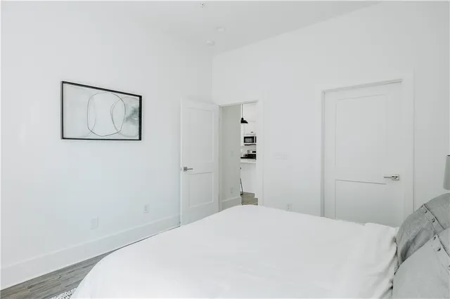 a bedroom with a bed and a wall painting