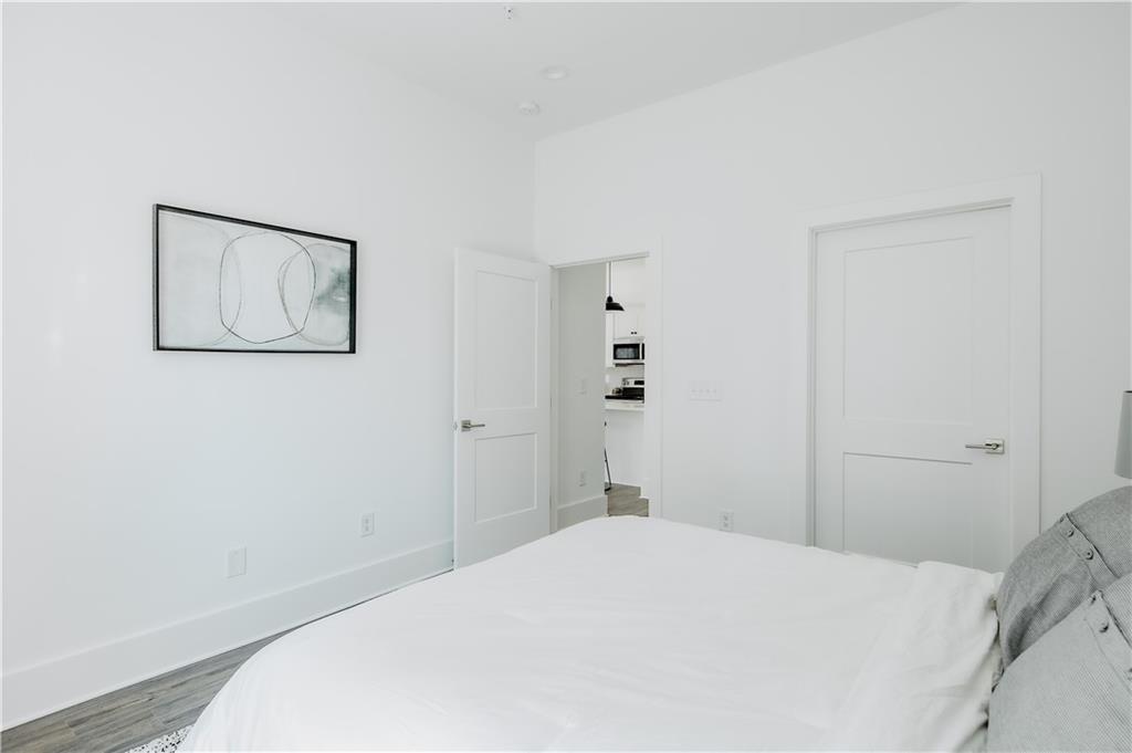 123 Mayson Avenue Northeast, Unit C Atlanta, GA 30307 - Photo 8 of 21 a bedroom with a bed and a wall painting