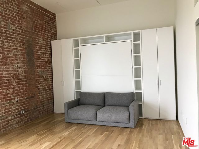 a living room with a couch and a potted plant