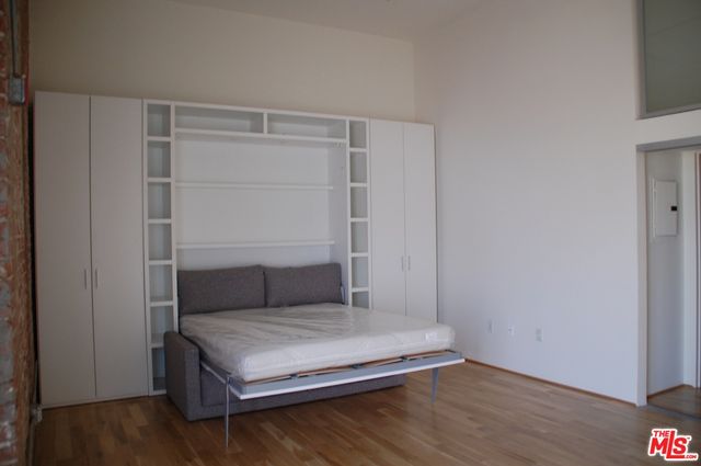 a living room with wooden floor and closet