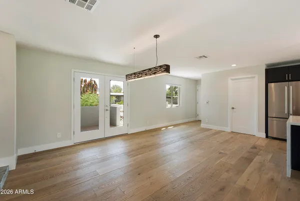 a view of kitchen with stainless steel appliances granite countertop cabinets and wooden floor