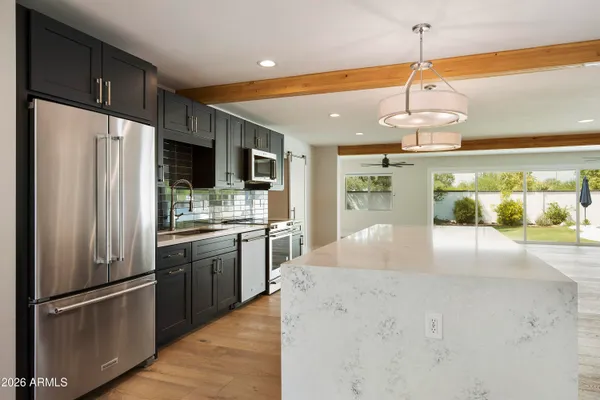 a kitchen with a sink and wooden floor