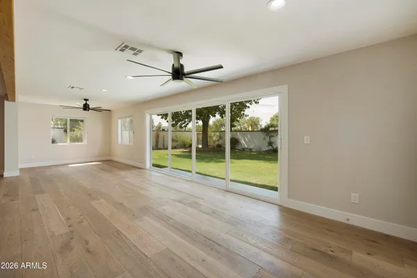 a view of empty room with wooden floor
