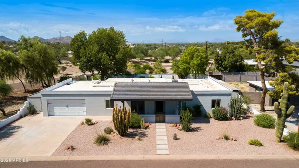 an aerial view of a house with a yard and sitting area