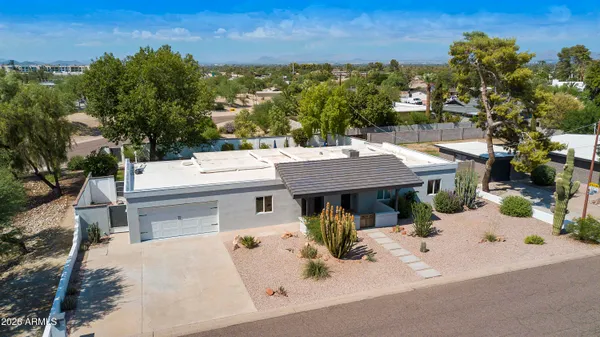an aerial view of residential houses with outdoor space and a street view