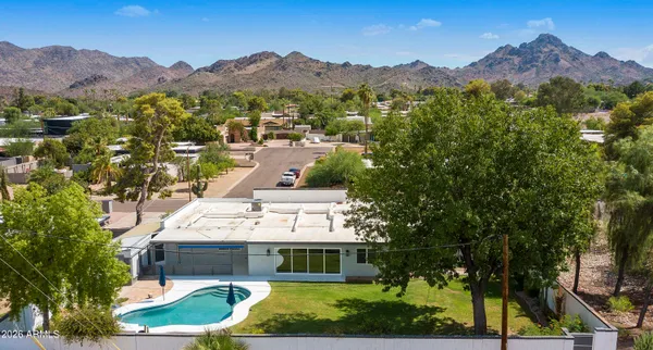 an aerial view of residential house with outdoor space and swimming pool