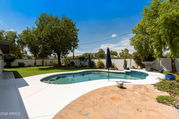 a view of a swimming pool with a yard