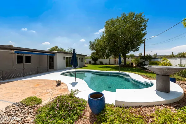 a view of a swimming pool with a patio