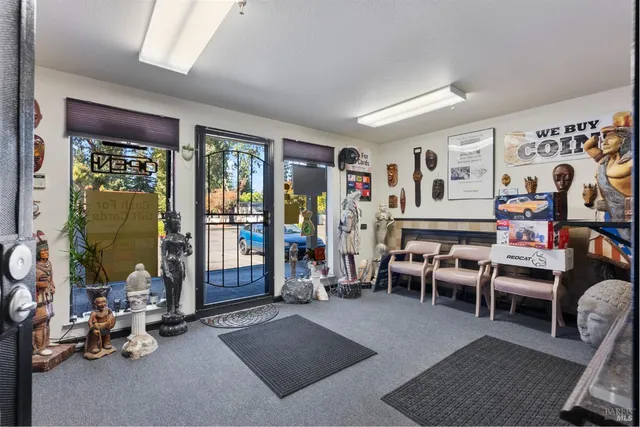 a living room with furniture a window and gym equipment