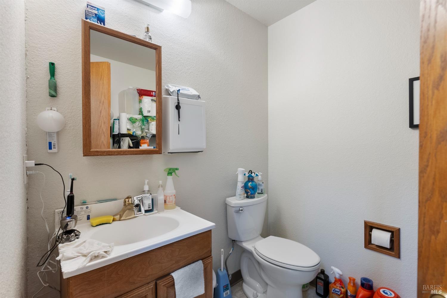 6650 Commerce Boulevard, Unit 16 Rohnert Park, CA 94928 - Photo 9 of 15 a bathroom with a sink vanity mirror and toilet