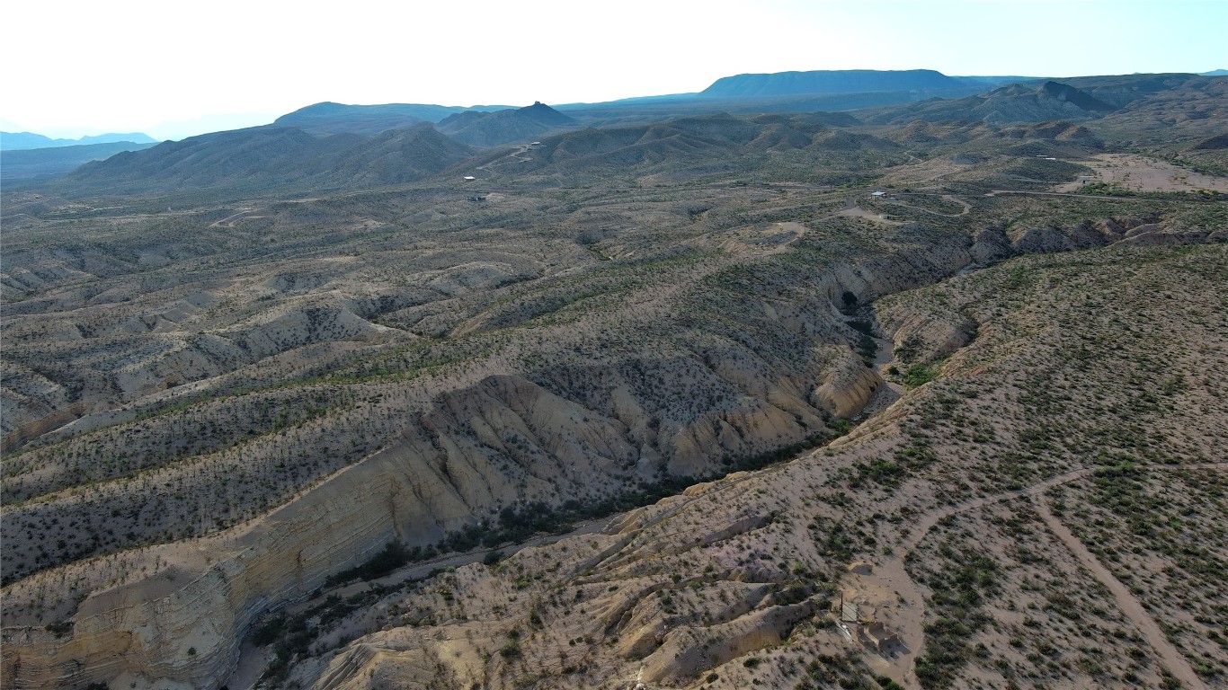 0 Herradura Road Terlingua, TX 79852 - Photo 9 of 20 a view of a dry yard with mountains in the background