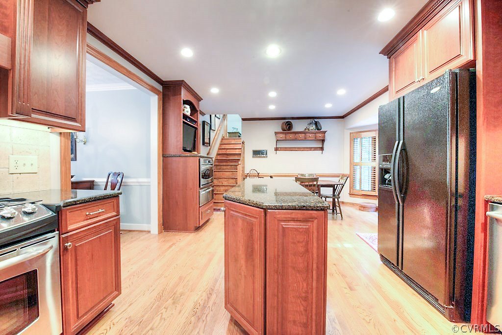 12808 Rivers Bend Road Chester, VA 23836 - Photo 22 of 41 a kitchen with stainless steel appliances granite countertop a refrigerator a stove and a wooden floors
