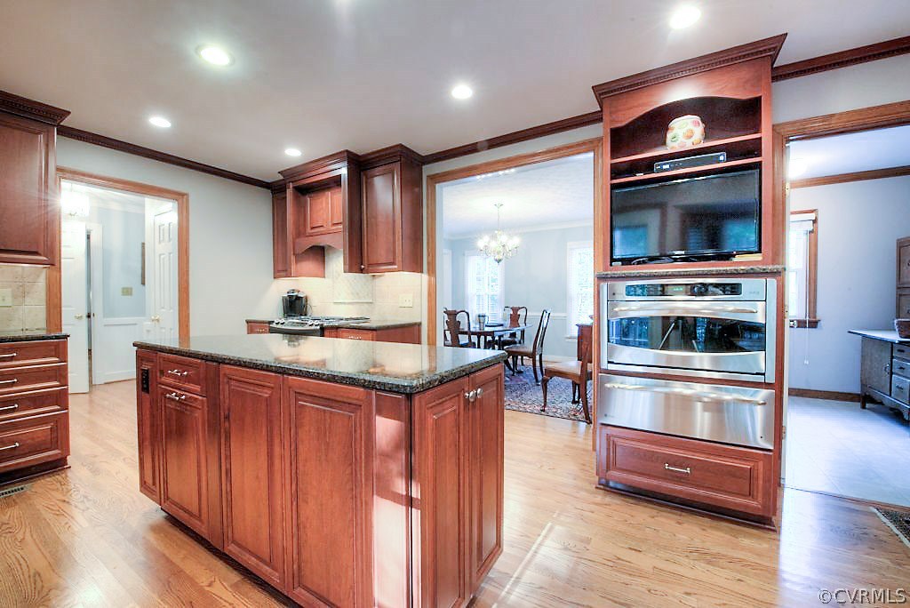 12808 Rivers Bend Road Chester, VA 23836 - Photo 24 of 41 a kitchen with stainless steel appliances kitchen island granite countertop a refrigerator and a stove top oven