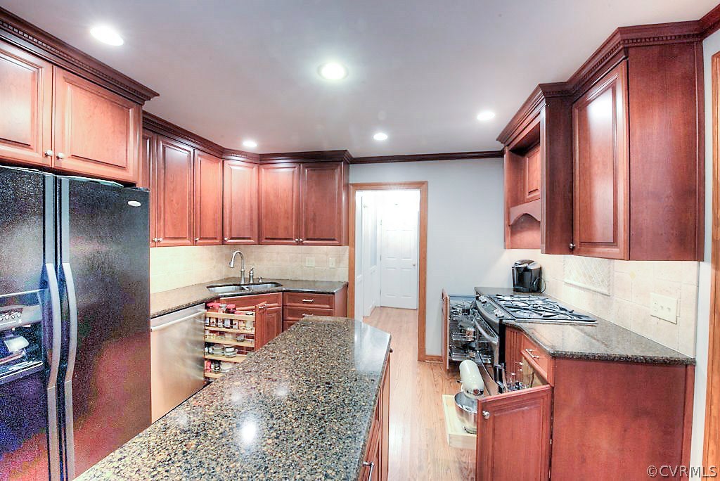 12808 Rivers Bend Road Chester, VA 23836 - Photo 26 of 41 a kitchen with stainless steel appliances granite countertop a refrigerator a stove and a sink