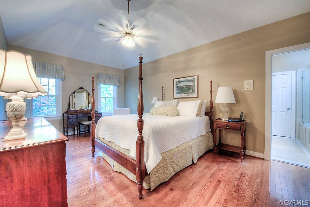 12808 Rivers Bend Road Chester, VA 23836 - Photo 30 of 41 a bed room with a bed and a chandelier