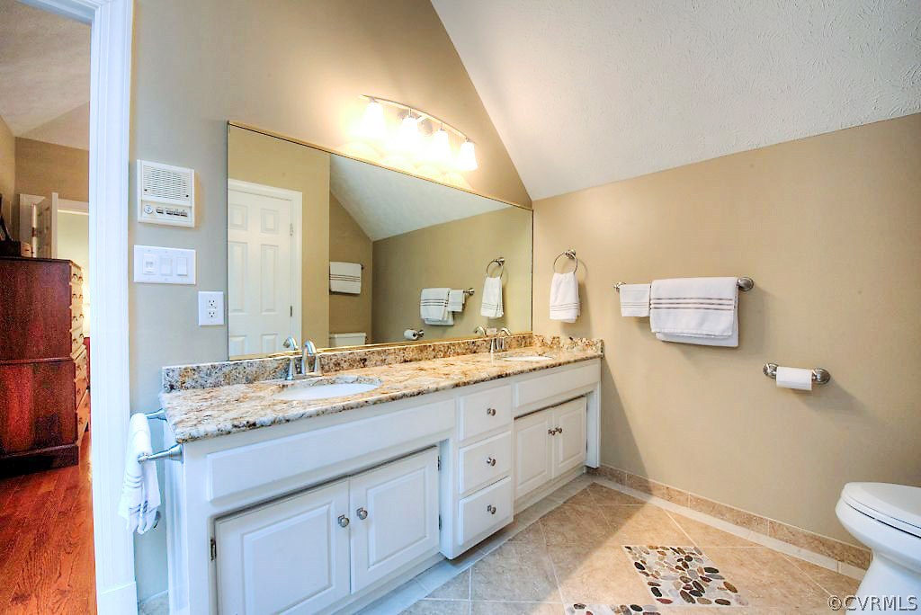 12808 Rivers Bend Road Chester, VA 23836 - Photo 32 of 41 a bathroom with a granite countertop sink mirror vanity and toilet