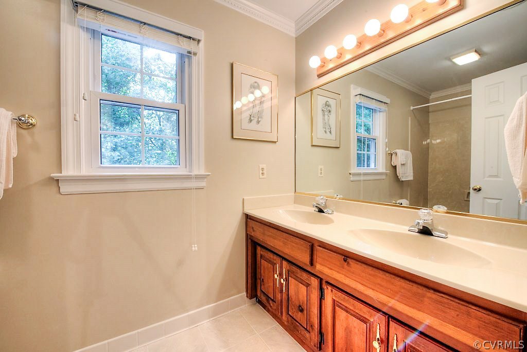 12808 Rivers Bend Road Chester, VA 23836 - Photo 34 of 41 a bathroom with a double vanity sink and a mirror