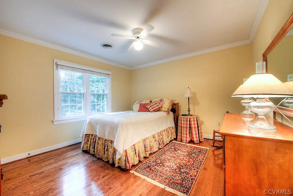 12808 Rivers Bend Road Chester, VA 23836 - Photo 35 of 41 a bedroom with a bed and wooden floor