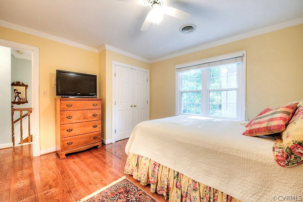 12808 Rivers Bend Road Chester, VA 23836 - Photo 36 of 41 a bedroom with a bed and wooden floor