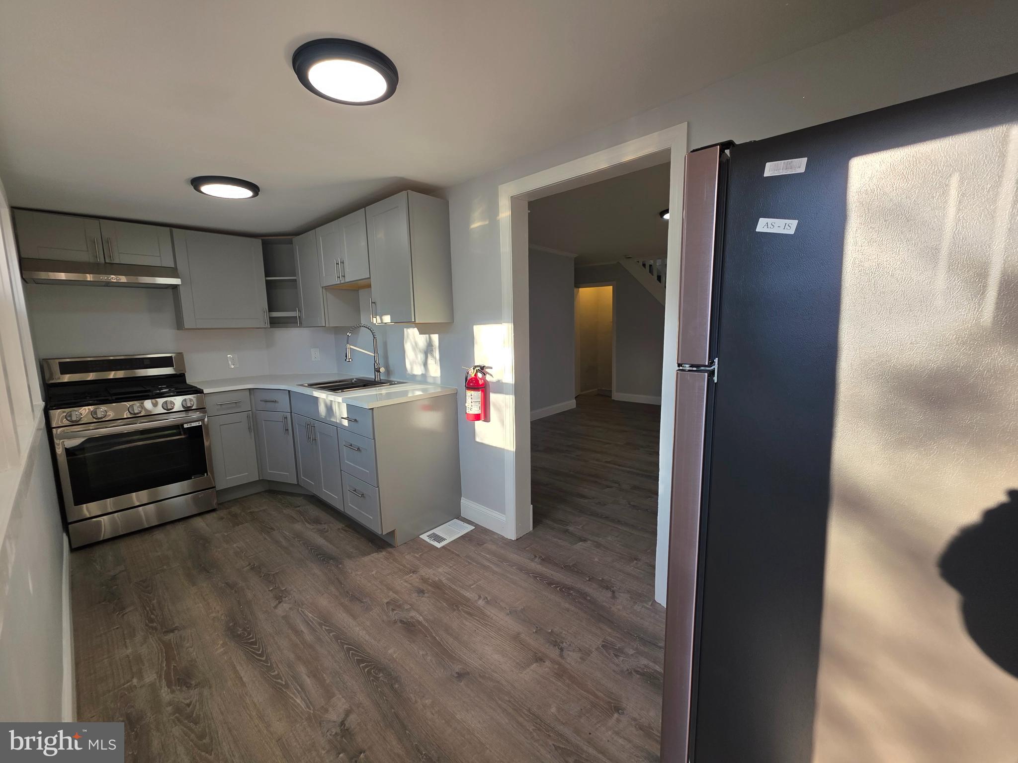 340 Middlesex Street Gloucester City, NJ 08030 - Photo 9 of 17 a kitchen with a sink and a refrigerator