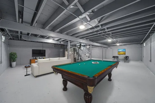 a room with furniture and pool table