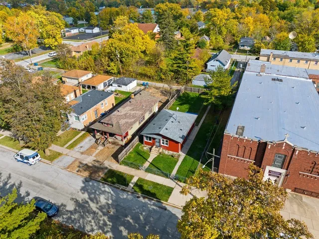 an aerial view of residential houses with outdoor space