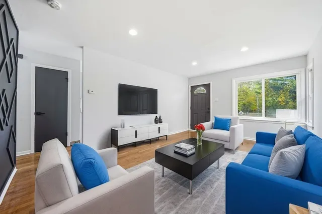 a living room with furniture and a flat screen tv