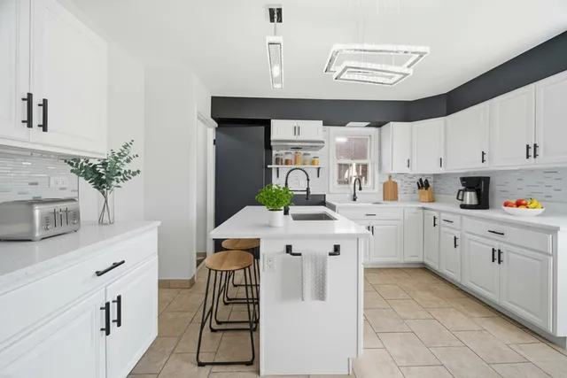 a kitchen with a sink window and cabinets