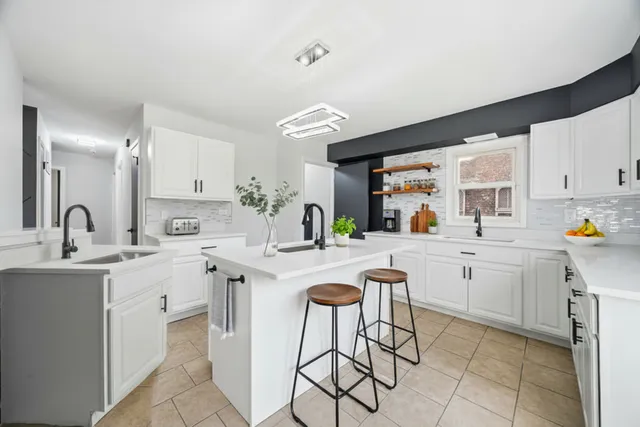 a kitchen with cabinets a sink and appliances