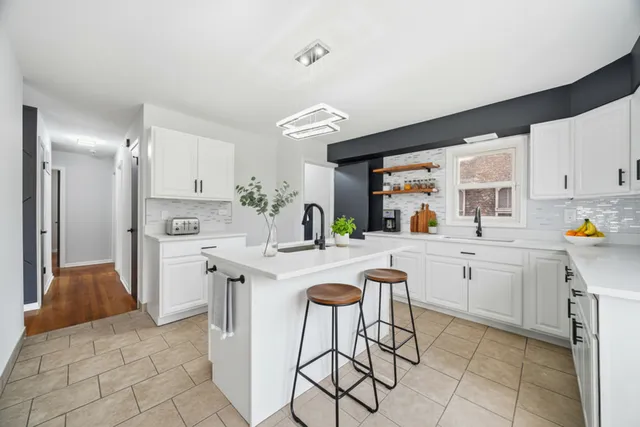 a kitchen with a sink cabinets and window