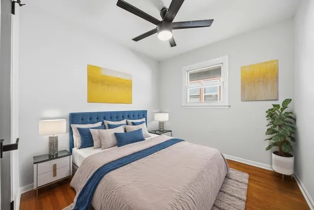 a bedroom with a bed and a potted plant