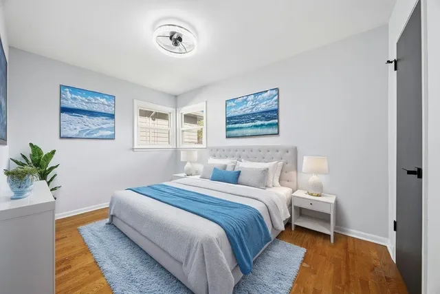 a bedroom with a bed and a painting on the wall