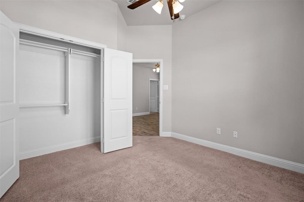 119 Happy Lane Red Oak, TX 75154 - Photo 26 of 37 Carpeted room featuring a double-door closet with shelving and hanging rods