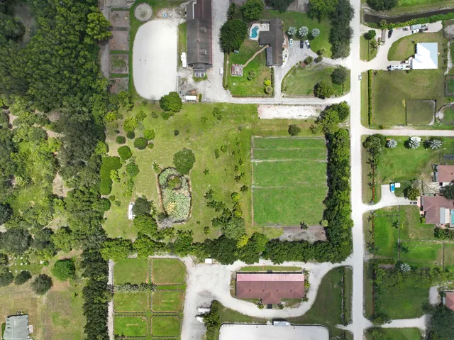 an aerial view of a residential houses with outdoor space