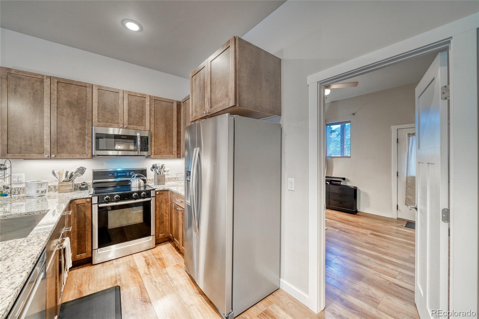 209 Summitview Lane Poncha Springs, CO 81201 - Photo 12 of 44 a kitchen with stainless steel appliances granite countertop a refrigerator and a stove