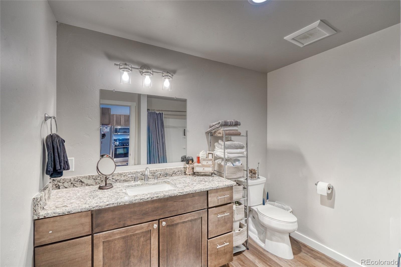 209 Summitview Lane Poncha Springs, CO 81201 - Photo 14 of 44 a bathroom with a granite countertop toilet sink and mirror