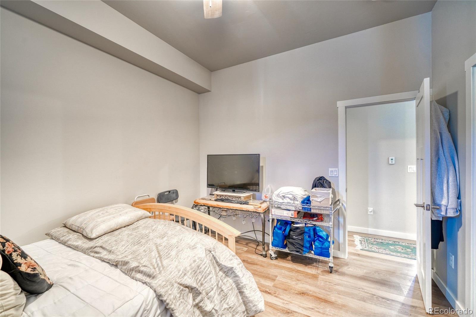 209 Summitview Lane Poncha Springs, CO 81201 - Photo 16 of 44 a bedroom with a bed and wooden floor