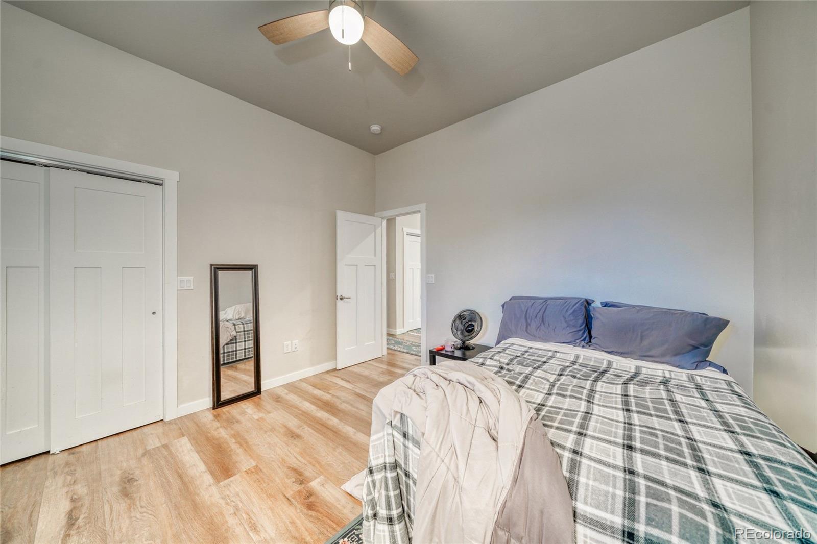 209 Summitview Lane Poncha Springs, CO 81201 - Photo 18 of 44 a bedroom with a large bed and a chandelier