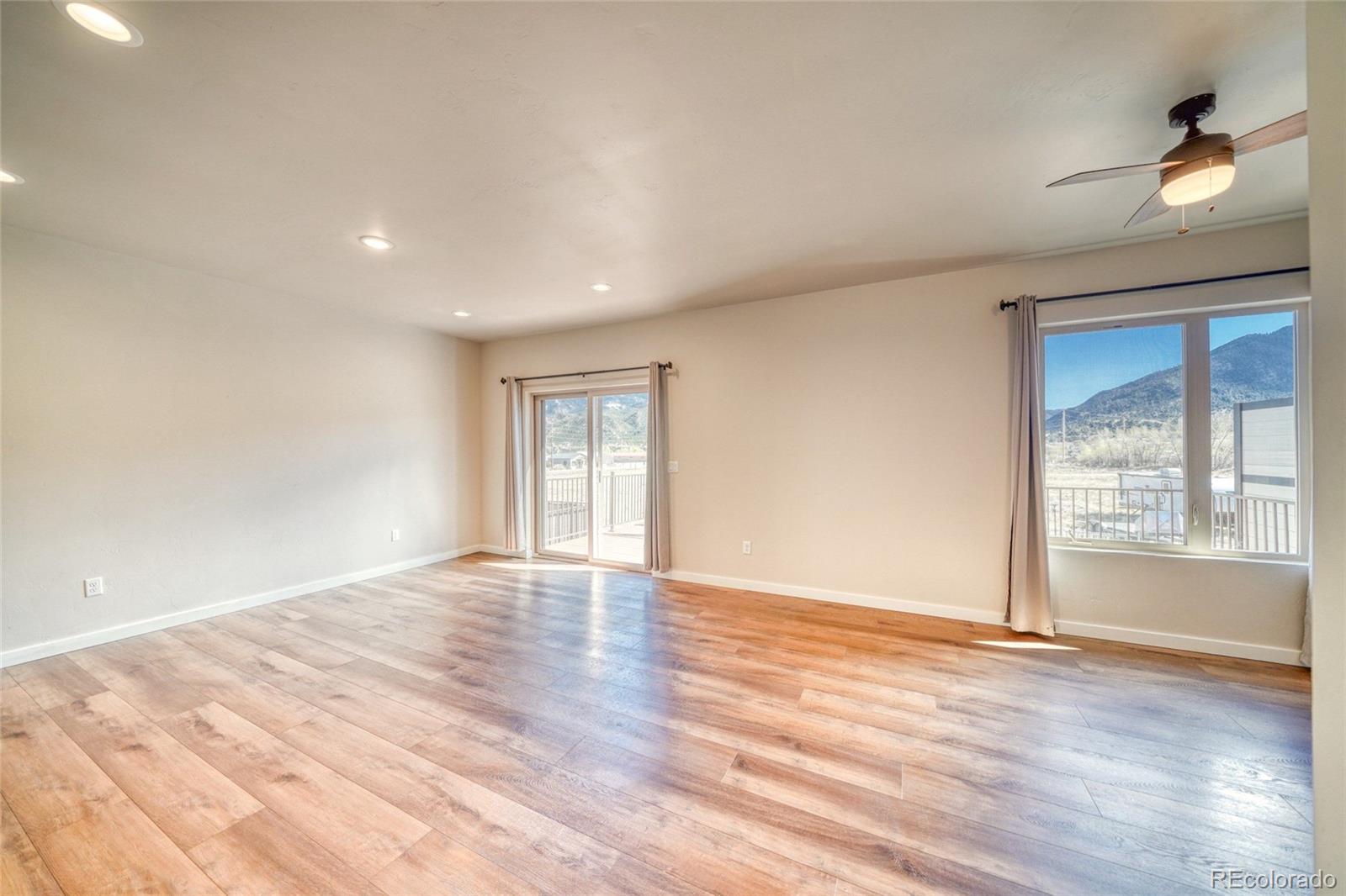 209 Summitview Lane Poncha Springs, CO 81201 - Photo 24 of 44 a view of an empty room with wooden floor and a window