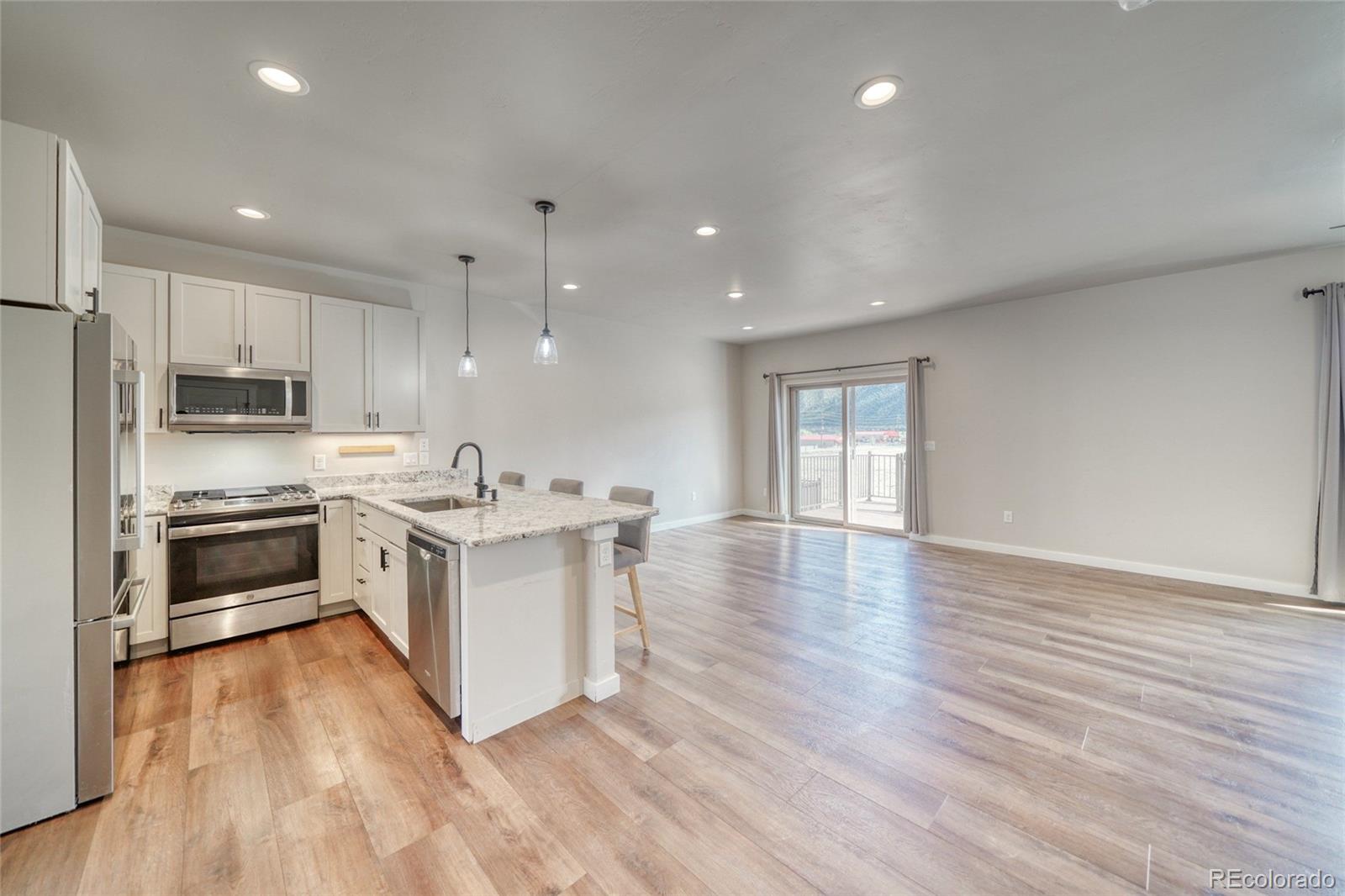 209 Summitview Lane Poncha Springs, CO 81201 - Photo 28 of 44 a kitchen with stainless steel appliances a white stove top oven and a refrigerator
