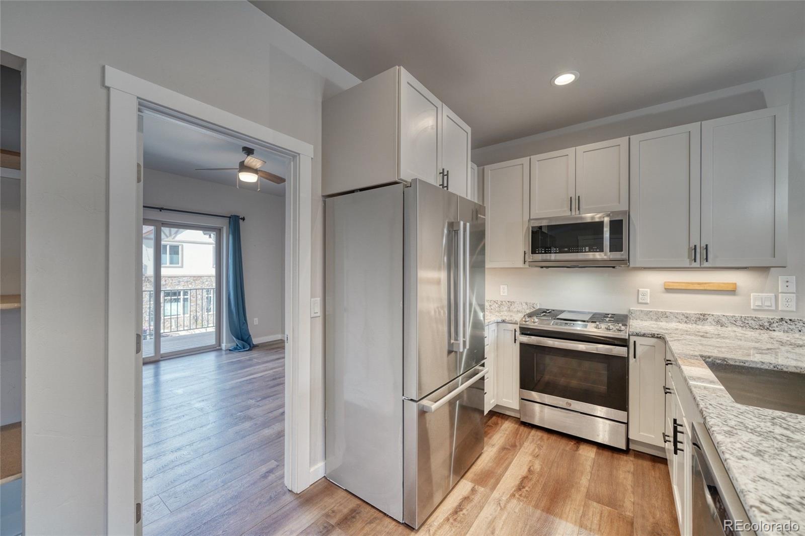 209 Summitview Lane Poncha Springs, CO 81201 - Photo 29 of 44 a kitchen with stainless steel appliances granite countertop a stove a refrigerator and a microwave oven