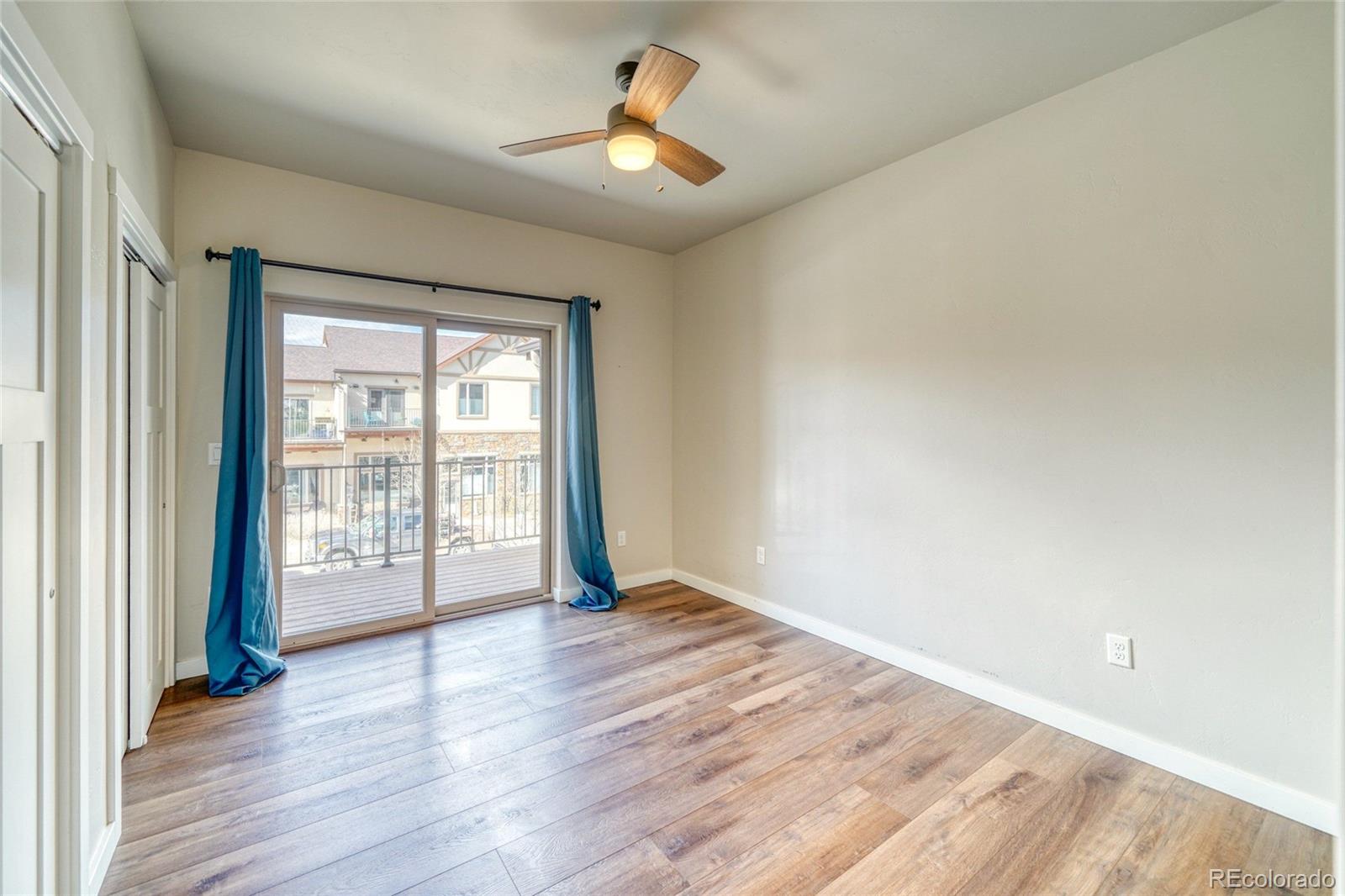 209 Summitview Lane Poncha Springs, CO 81201 - Photo 31 of 44 a view of an empty room with window and wooden floor