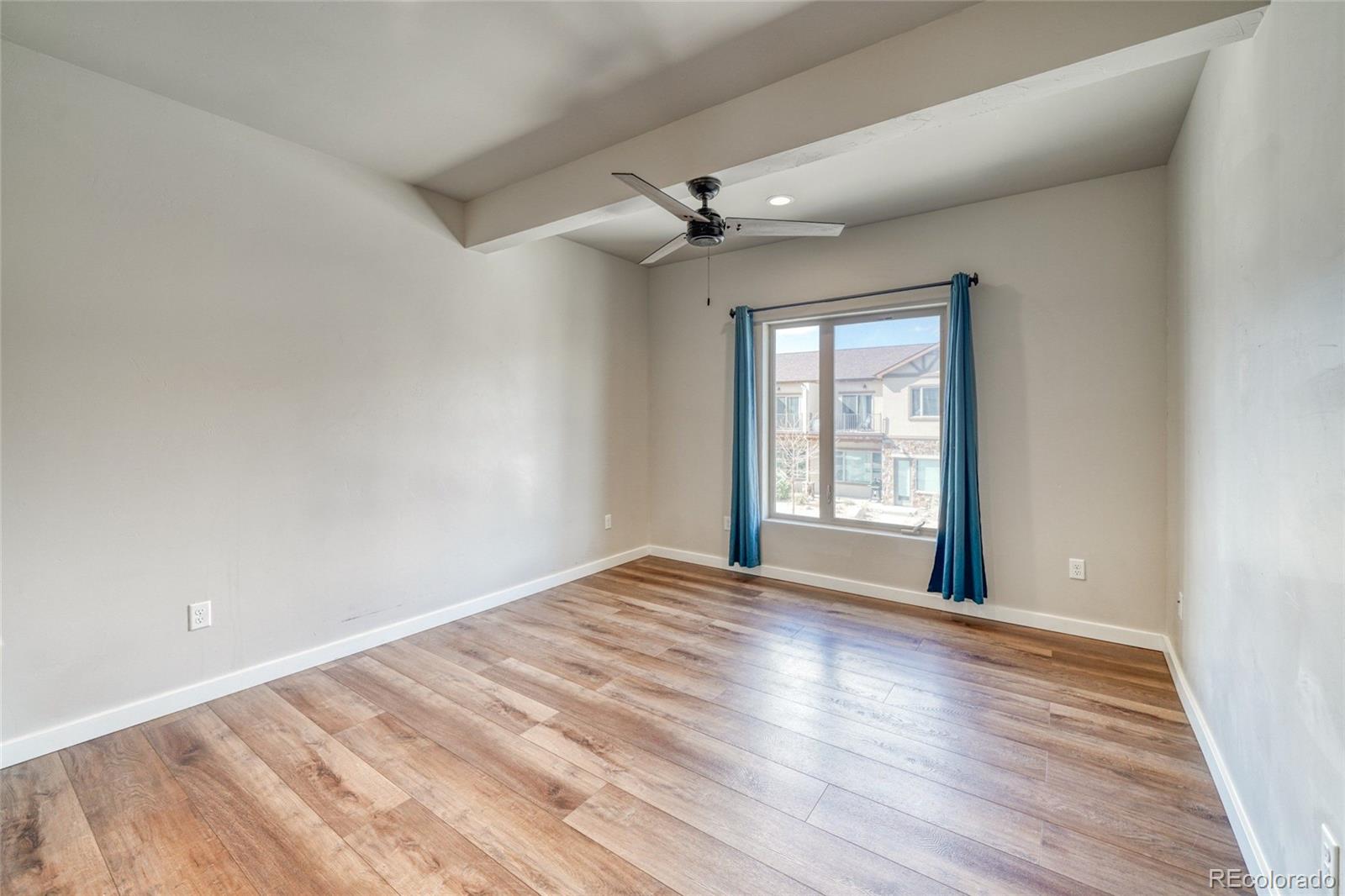 209 Summitview Lane Poncha Springs, CO 81201 - Photo 35 of 44 a view of an empty room with a window and wooden floor