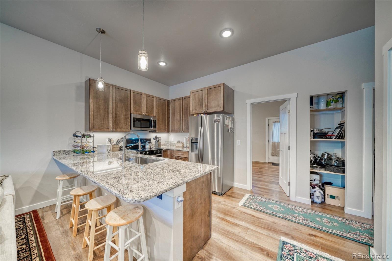 209 Summitview Lane Poncha Springs, CO 81201 - Photo 10 of 44 a kitchen with stainless steel appliances granite countertop a sink refrigerator and cabinets