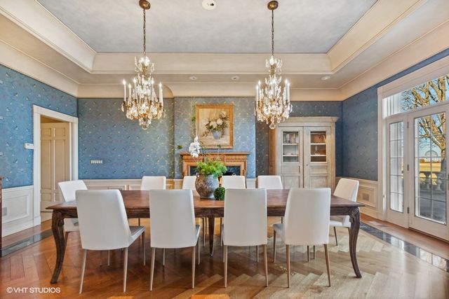 a view of a dining room with furniture window chandelier and wooden floor
