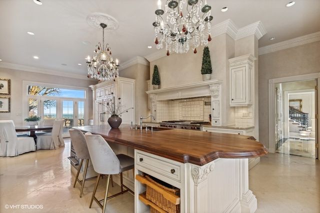 a kitchen with a counter space a sink appliances and cabinets